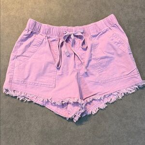 Light purple juniors denim shorts with frayed hem.